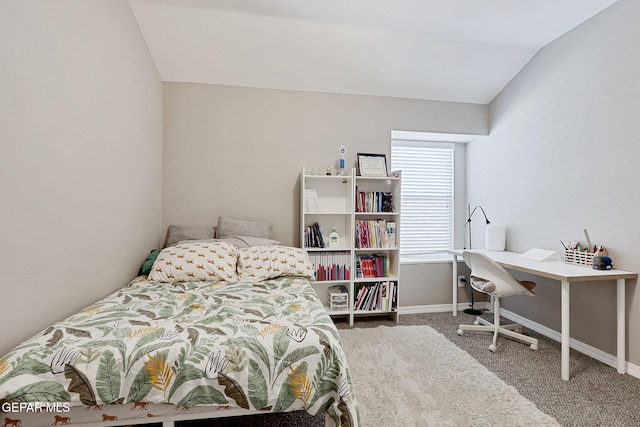 carpeted bedroom with vaulted ceiling and baseboards