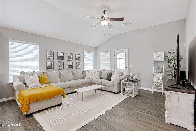 living room with ceiling fan, baseboards, wood finished floors, and vaulted ceiling