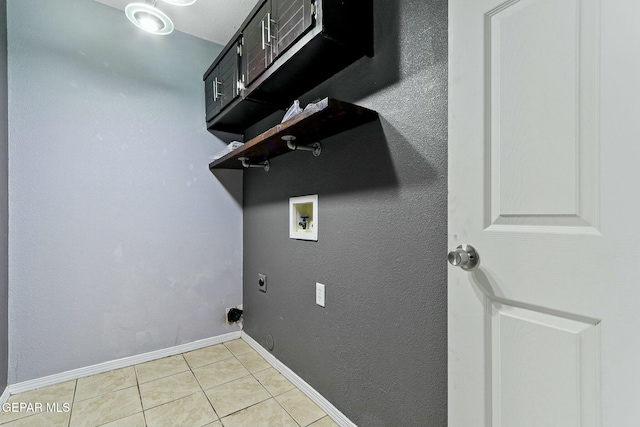 clothes washing area featuring baseboards, light tile patterned floors, laundry area, hookup for a washing machine, and hookup for an electric dryer