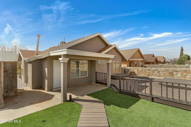 back of house with stucco siding, a patio, and fence