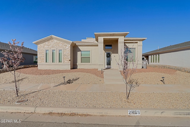 view of front of property featuring stone siding and stucco siding