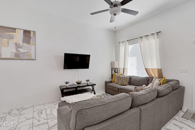 living area featuring baseboards, marble finish floor, and a ceiling fan