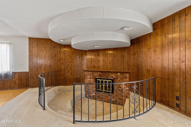 interior space with an upstairs landing and wooden walls