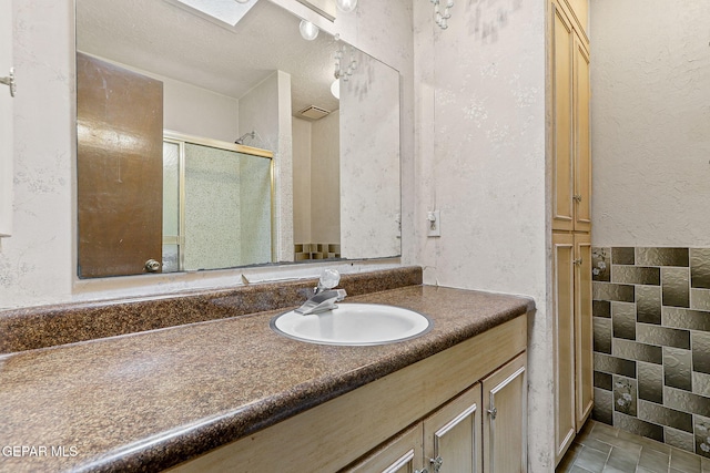 full bathroom featuring vanity, a shower stall, and tile patterned flooring