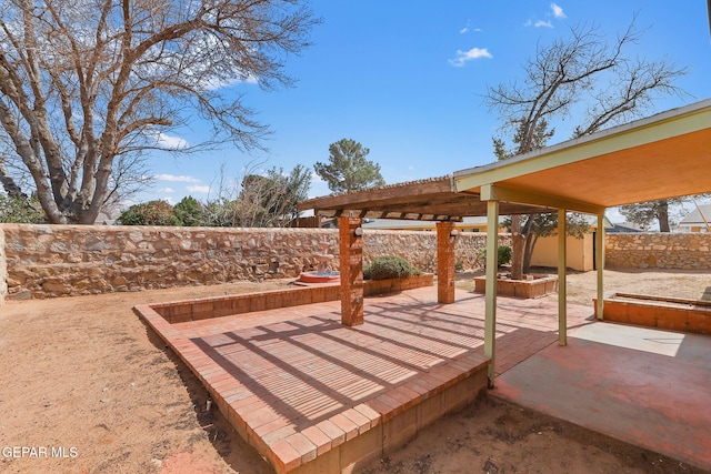 deck with a fenced backyard and a patio