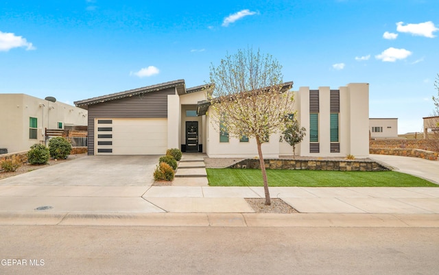 modern home featuring an attached garage and concrete driveway