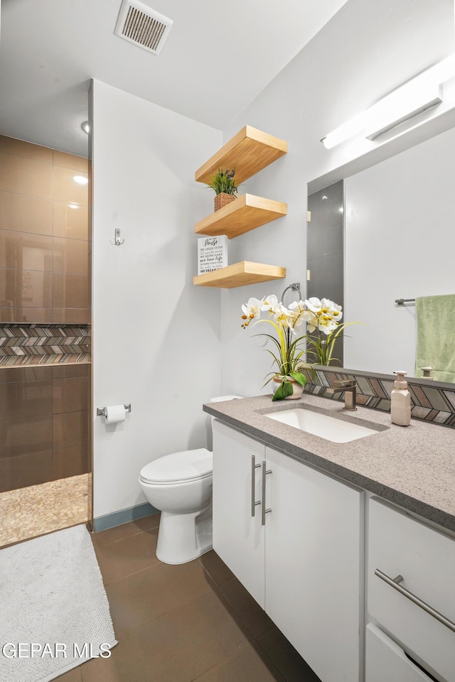 full bath with visible vents, walk in shower, toilet, tile patterned floors, and vanity