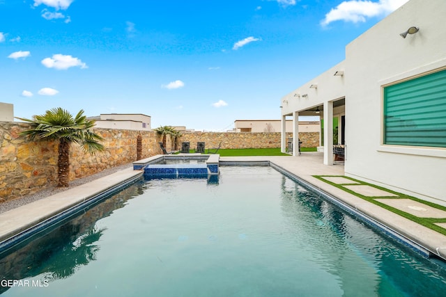 view of pool featuring a patio, a fenced backyard, and a pool with connected hot tub