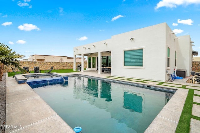 view of swimming pool with a patio, a fenced backyard, a pool with connected hot tub, and ceiling fan