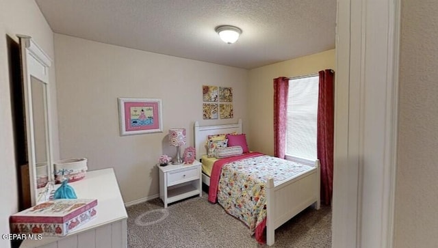 bedroom featuring carpet flooring, a textured ceiling, and baseboards