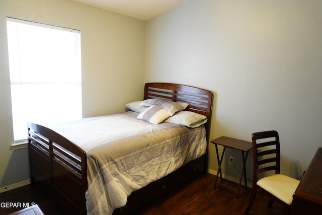 bedroom with baseboards and wood finished floors