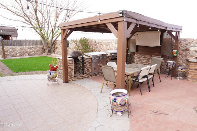 view of patio / terrace featuring exterior kitchen, outdoor dining area, a fenced backyard, a gazebo, and a grill