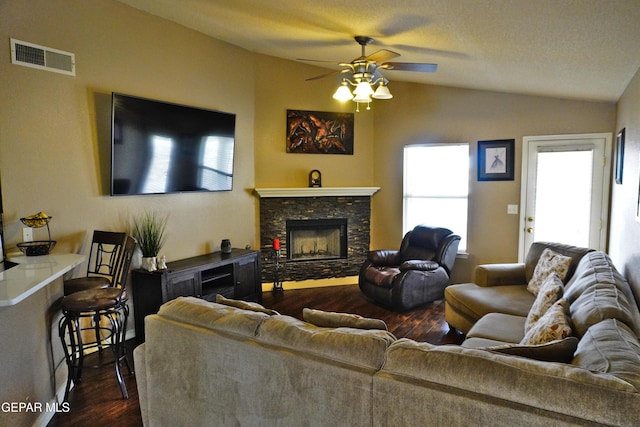 living area with visible vents, lofted ceiling, ceiling fan, and dark wood-style flooring