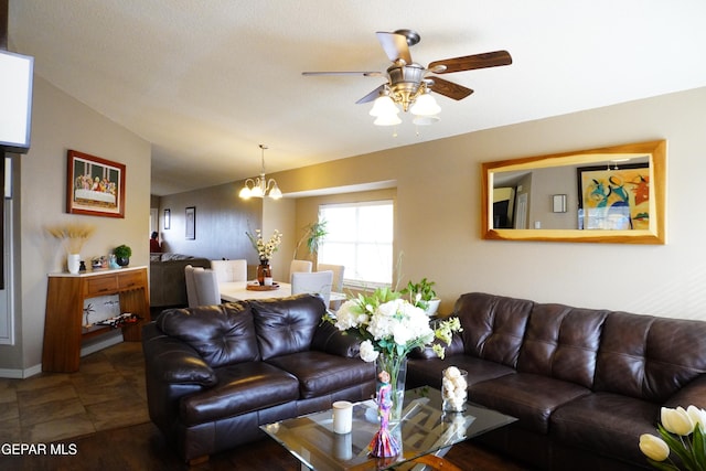 living area with ceiling fan with notable chandelier and lofted ceiling