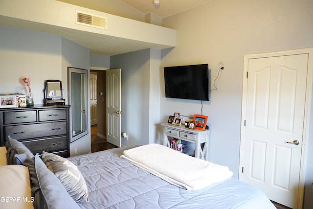 bedroom with visible vents and vaulted ceiling