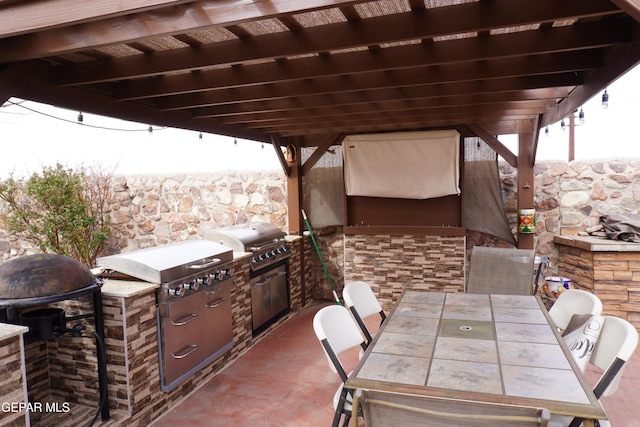 view of patio / terrace featuring area for grilling, outdoor dining space, and exterior kitchen