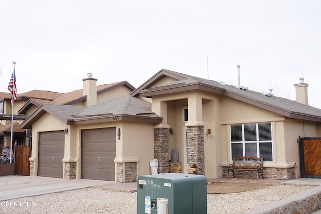 view of front of house featuring a garage, stone siding, and a chimney