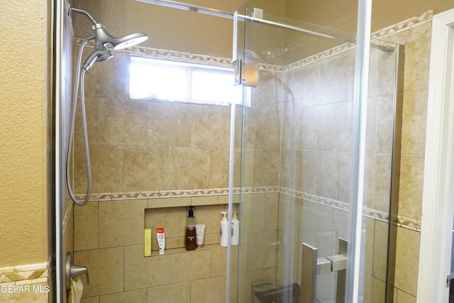 full bath with a shower stall