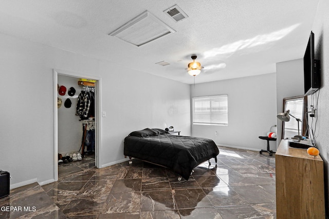 bedroom featuring visible vents, baseboards, a textured ceiling, and marble finish floor