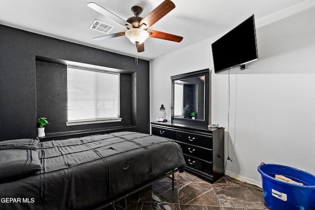 bedroom with visible vents, baseboards, marble finish floor, and ceiling fan