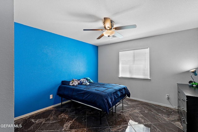 bedroom with a ceiling fan, visible vents, baseboards, and marble finish floor