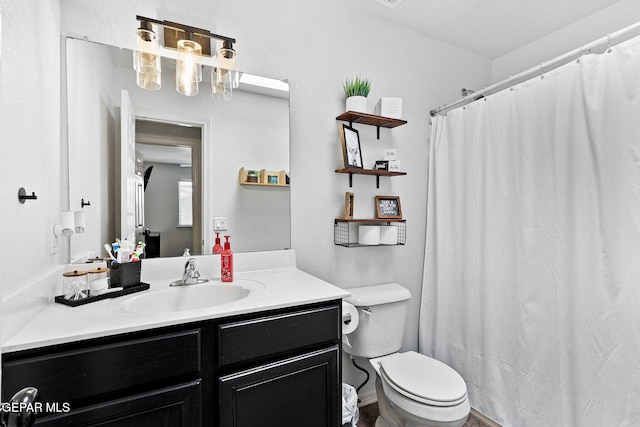 full bath featuring vanity and toilet