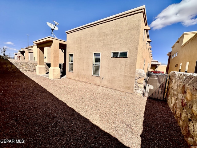 back of property with a patio area, fence, and stucco siding