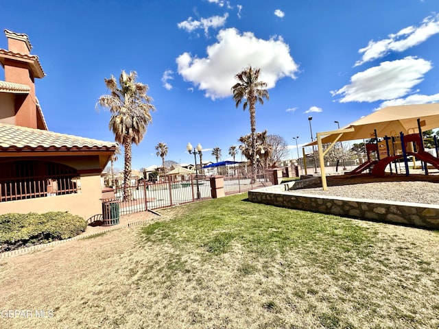 view of yard with playground community and fence