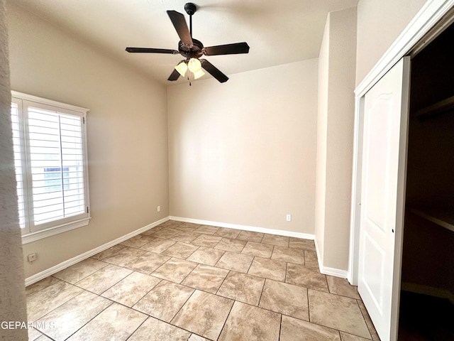 unfurnished bedroom featuring a ceiling fan, tile patterned floors, baseboards, and a closet