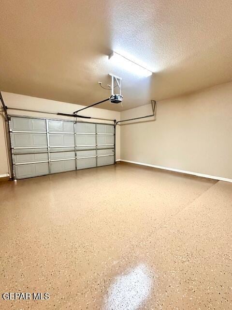 garage featuring baseboards and a garage door opener