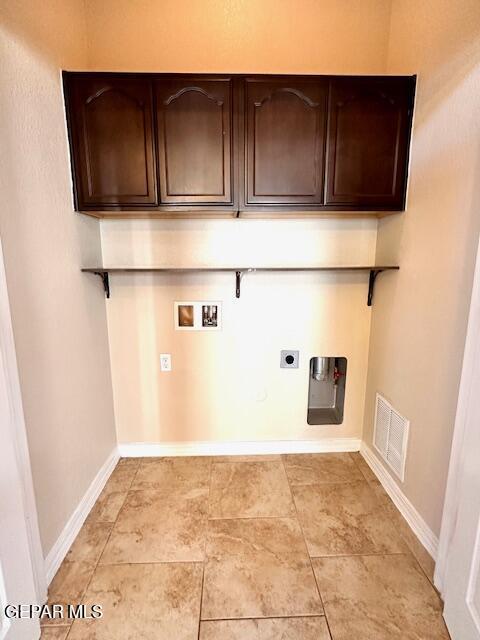 laundry area featuring visible vents, baseboards, washer hookup, cabinet space, and hookup for an electric dryer