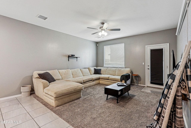 living room with visible vents, baseboards, ceiling fan, and light tile patterned flooring