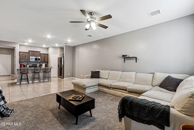 living room featuring light tile patterned floors, visible vents, recessed lighting, and ceiling fan