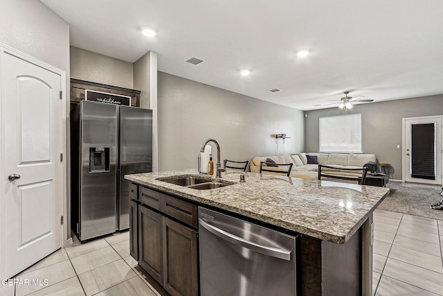 kitchen featuring visible vents, ceiling fan, dark brown cabinetry, stainless steel appliances, and a sink