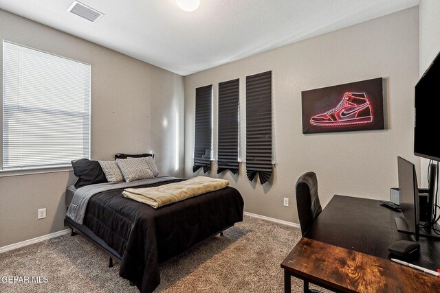 bedroom with visible vents, carpet floors, and baseboards