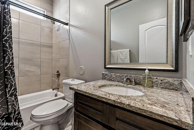 bathroom featuring shower / bathtub combination with curtain, toilet, vanity, and a textured wall