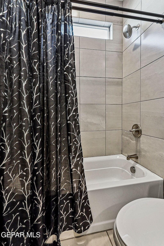 full bathroom featuring toilet and shower / bath combination with curtain