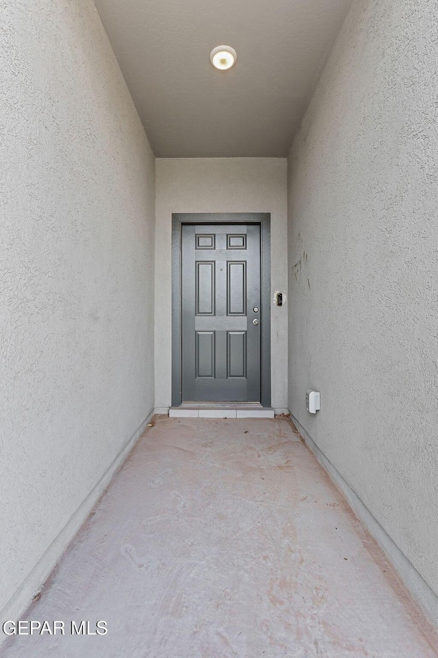 entrance to property with stucco siding