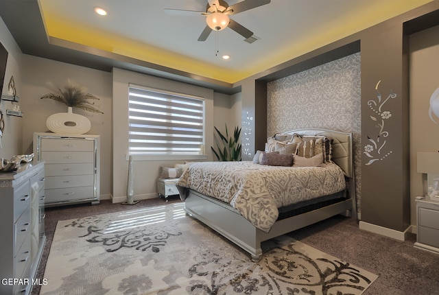 bedroom with a raised ceiling, carpet flooring, recessed lighting, and baseboards