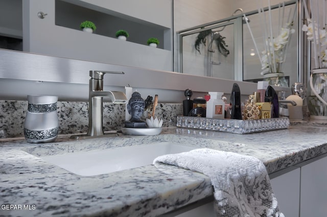 interior details featuring vanity and a shower stall