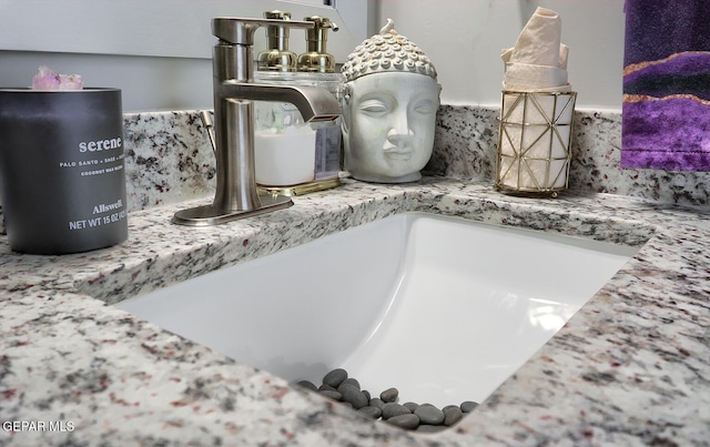 room details featuring tasteful backsplash and a sink