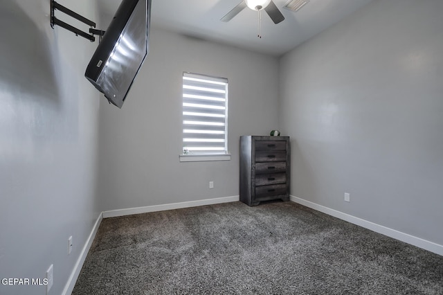 carpeted spare room with visible vents, a ceiling fan, and baseboards