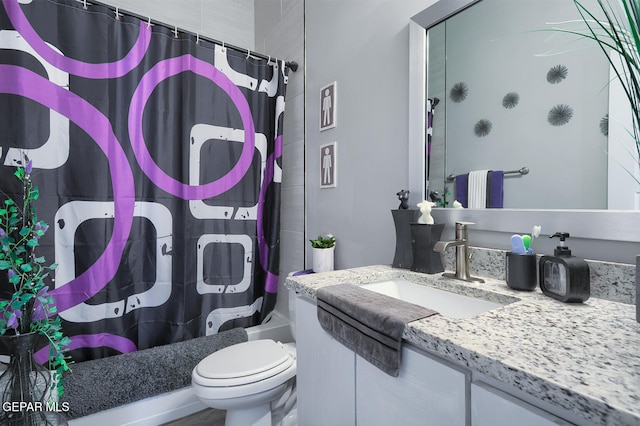 bathroom featuring shower / bathtub combination with curtain, toilet, and vanity