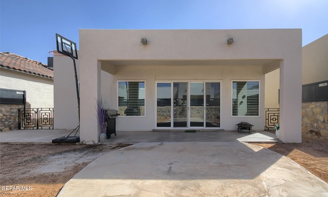 back of property featuring stucco siding and a patio