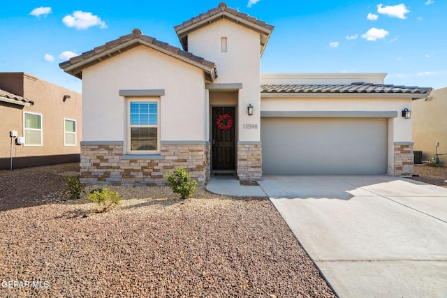 view of front of house featuring stone siding, stucco siding, driveway, and an attached garage