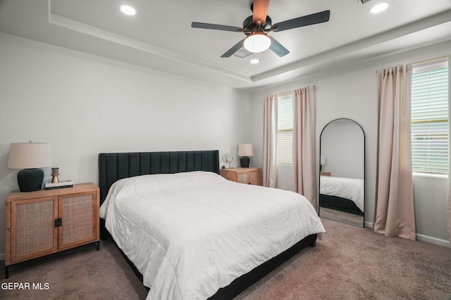 bedroom featuring a raised ceiling, recessed lighting, carpet, and ceiling fan