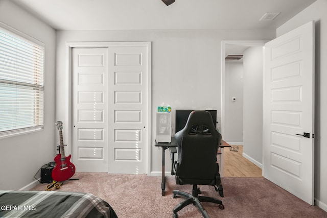 carpeted home office with visible vents and baseboards