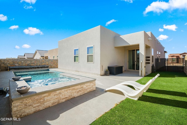 back of property featuring a patio, a yard, a fenced backyard, and stucco siding