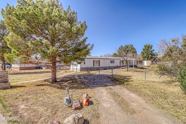 view of front of home featuring fence and driveway