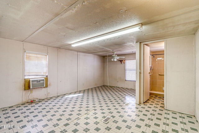 basement with a ceiling fan, cooling unit, and light floors